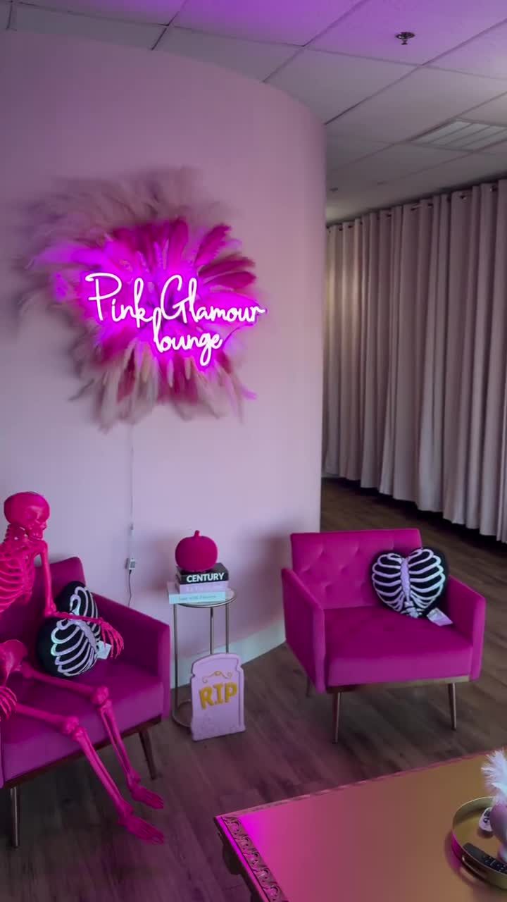 Pink Glamour Lounge neon sign over pink velvet chairs