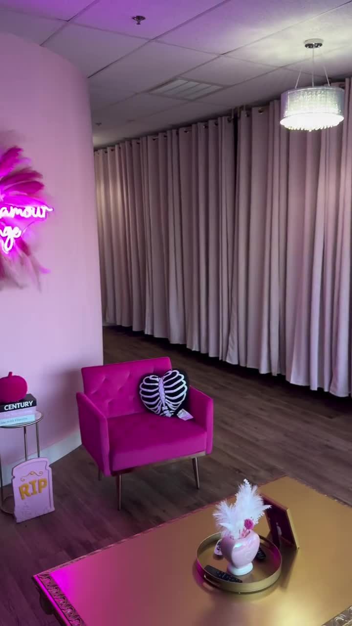 Hot pink lounge chairs and a gold table